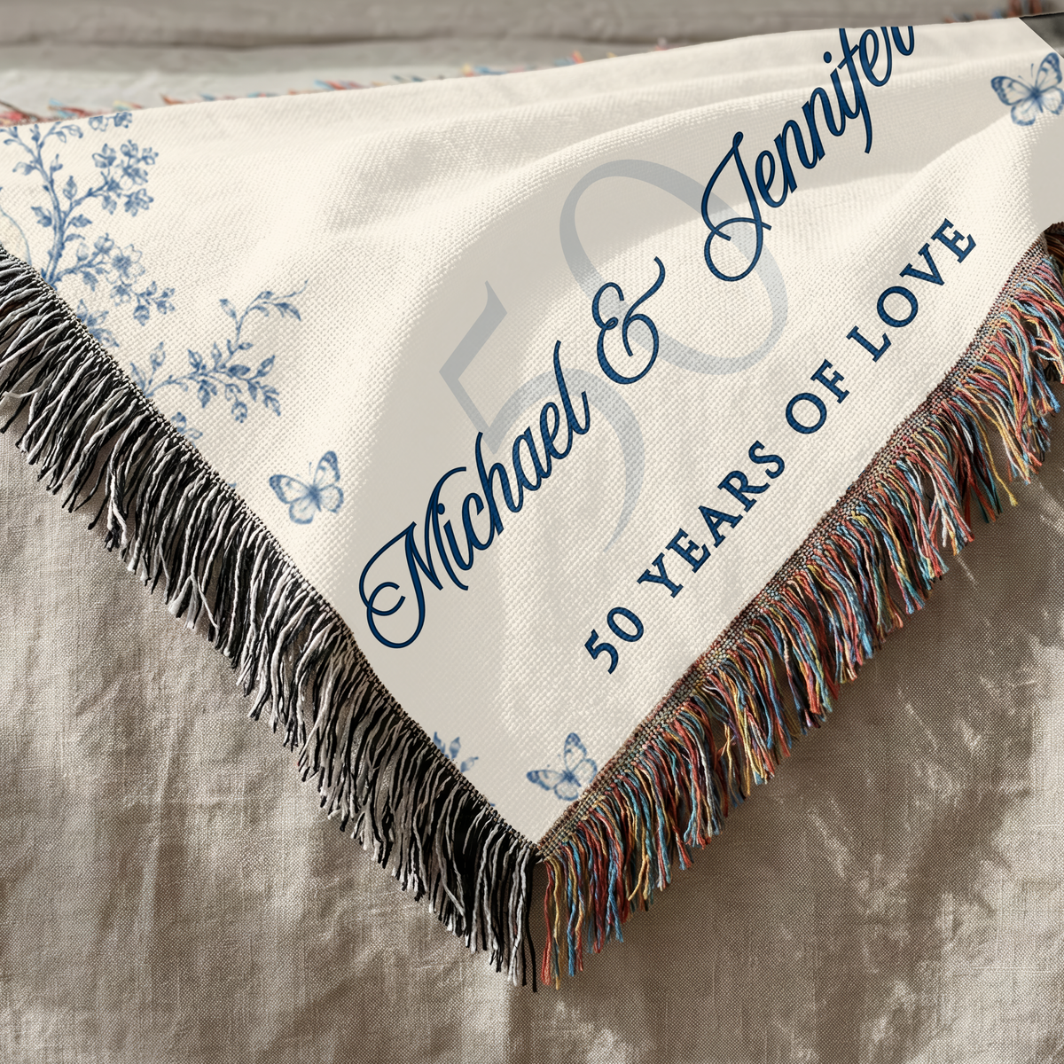 Close up of personalized 50th anniversary woven blanket showing cotton texture and decorative fringe