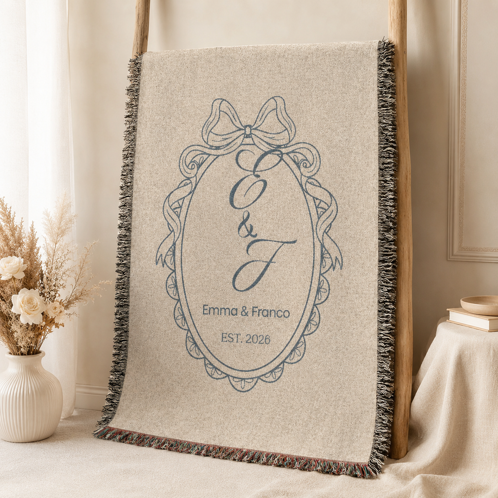 Personalized blue monogram wedding woven blanket displayed on a wooden ladder