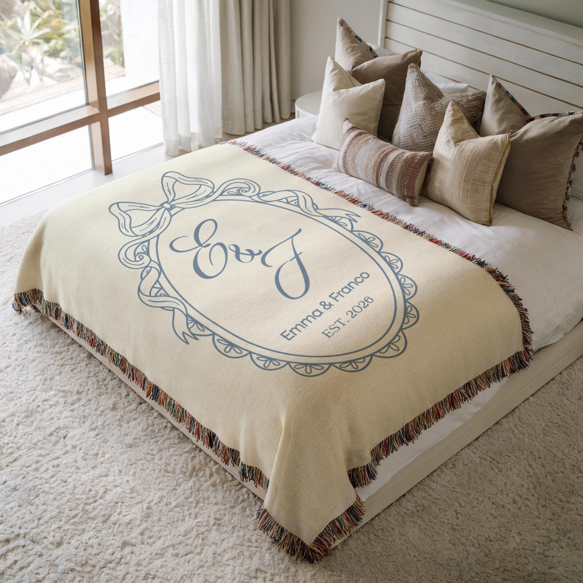Personalized blue wedding woven blanket styled on a neutral bed