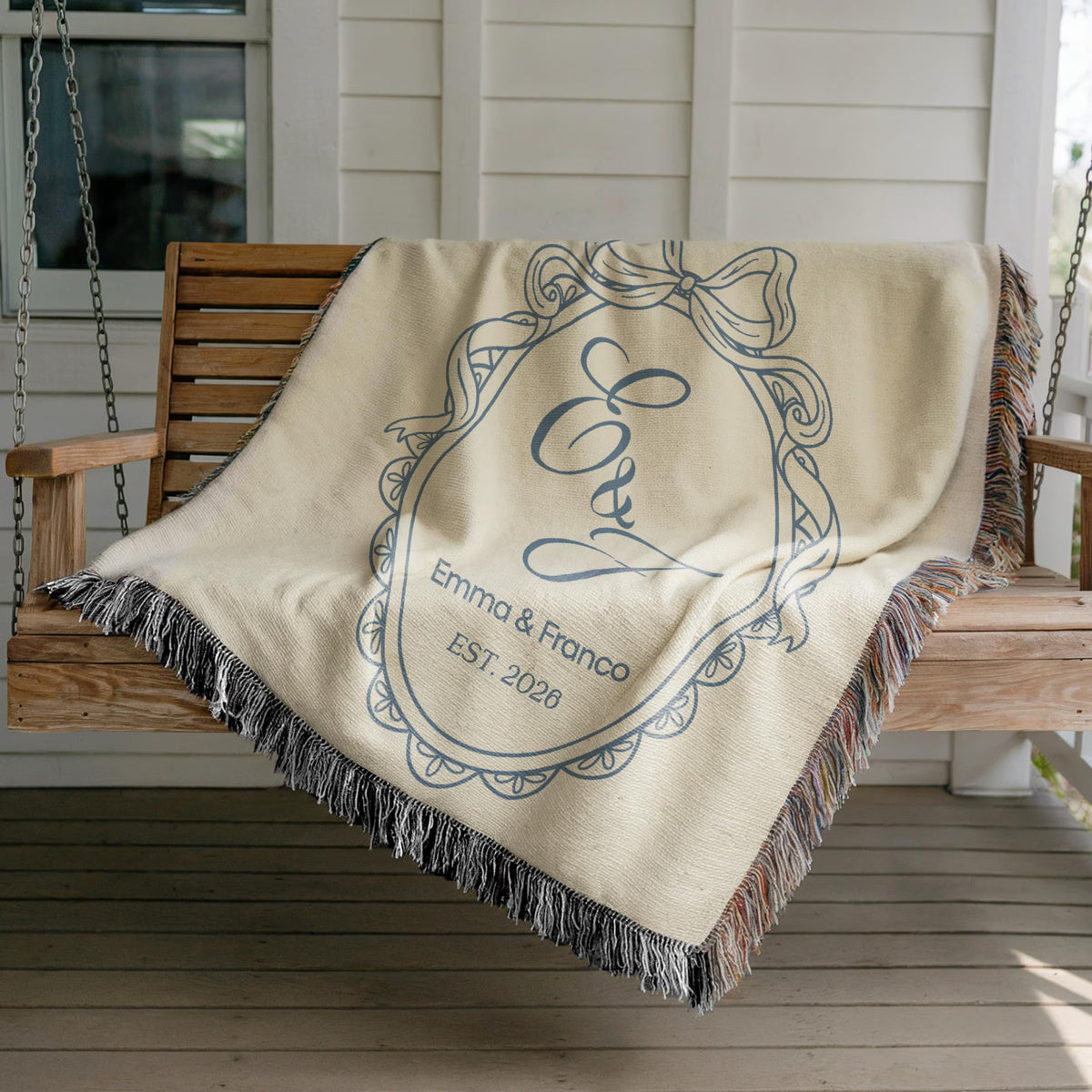 Personalized blue woven wedding blanket draped over a chair