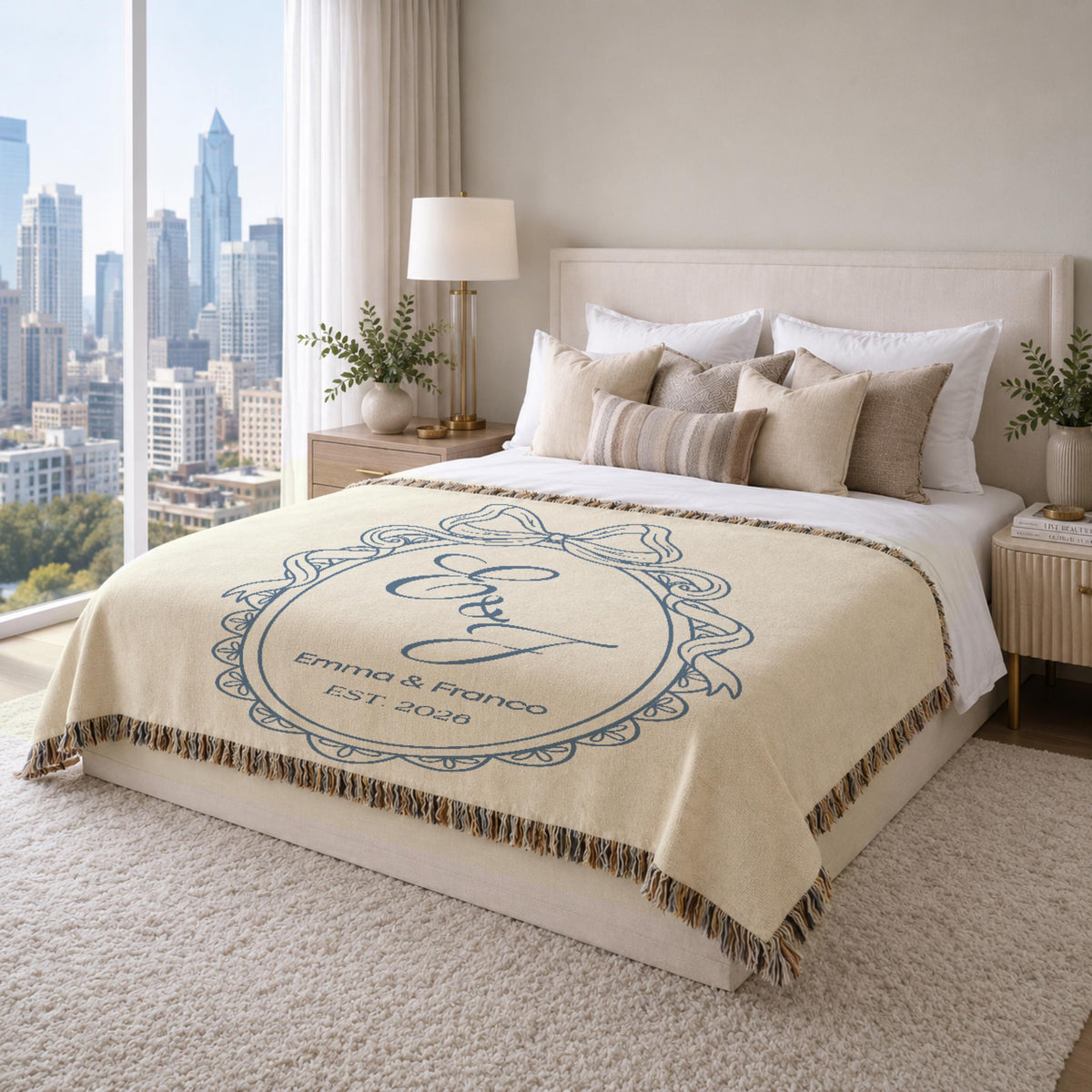 Custom monogram couple blanket displayed in an elegant modern bedroom