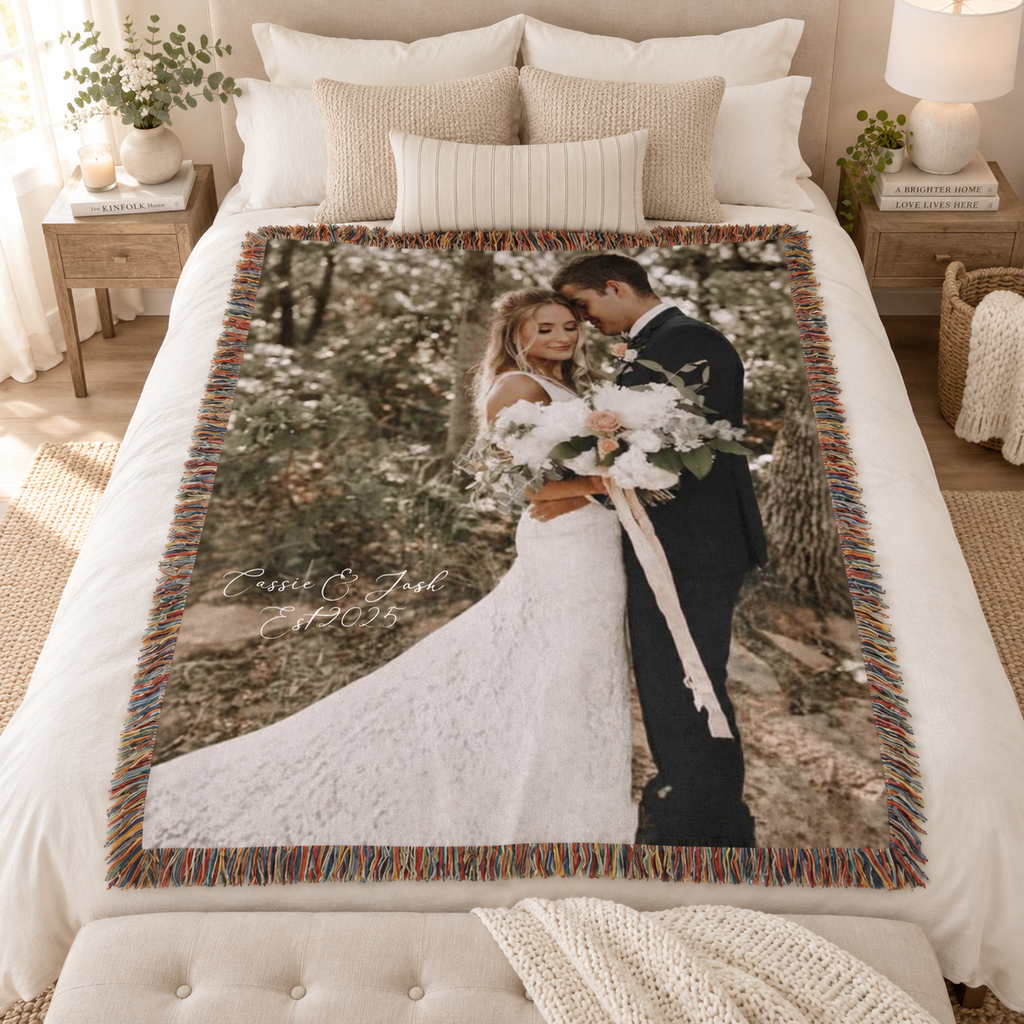 Custom wedding photo woven blanket displayed on a bed as a personalized newlywed gift