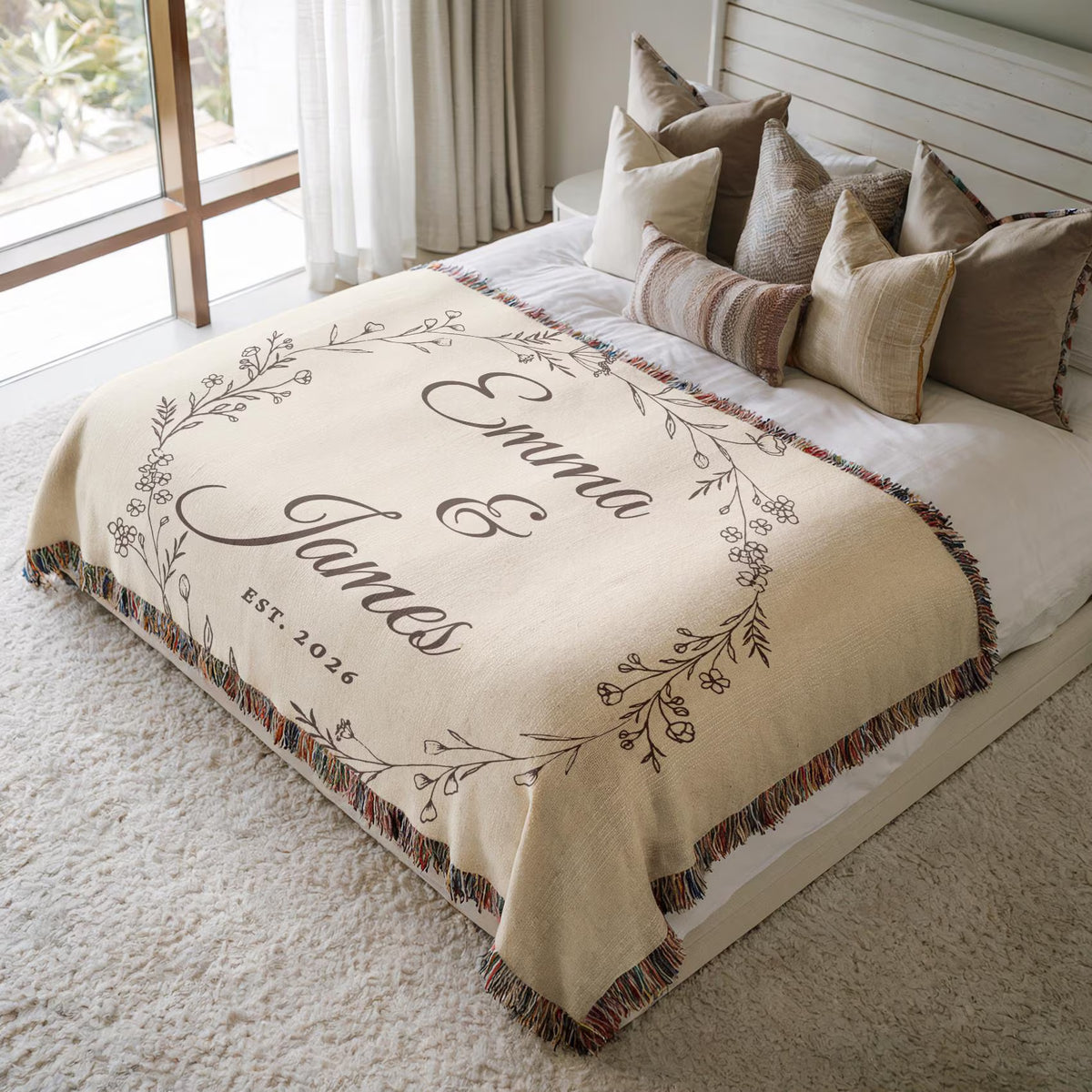 Personalized couple woven blanket with names displayed on a neutral bedroom bed
