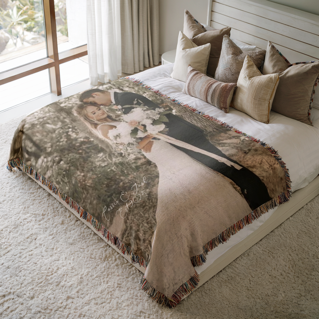 Wedding photo woven blanket with custom couple names shown on a neutral bed